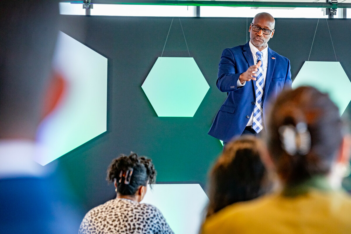 Dynamic talk underway as a speaker gestures confidently before an audience of students.